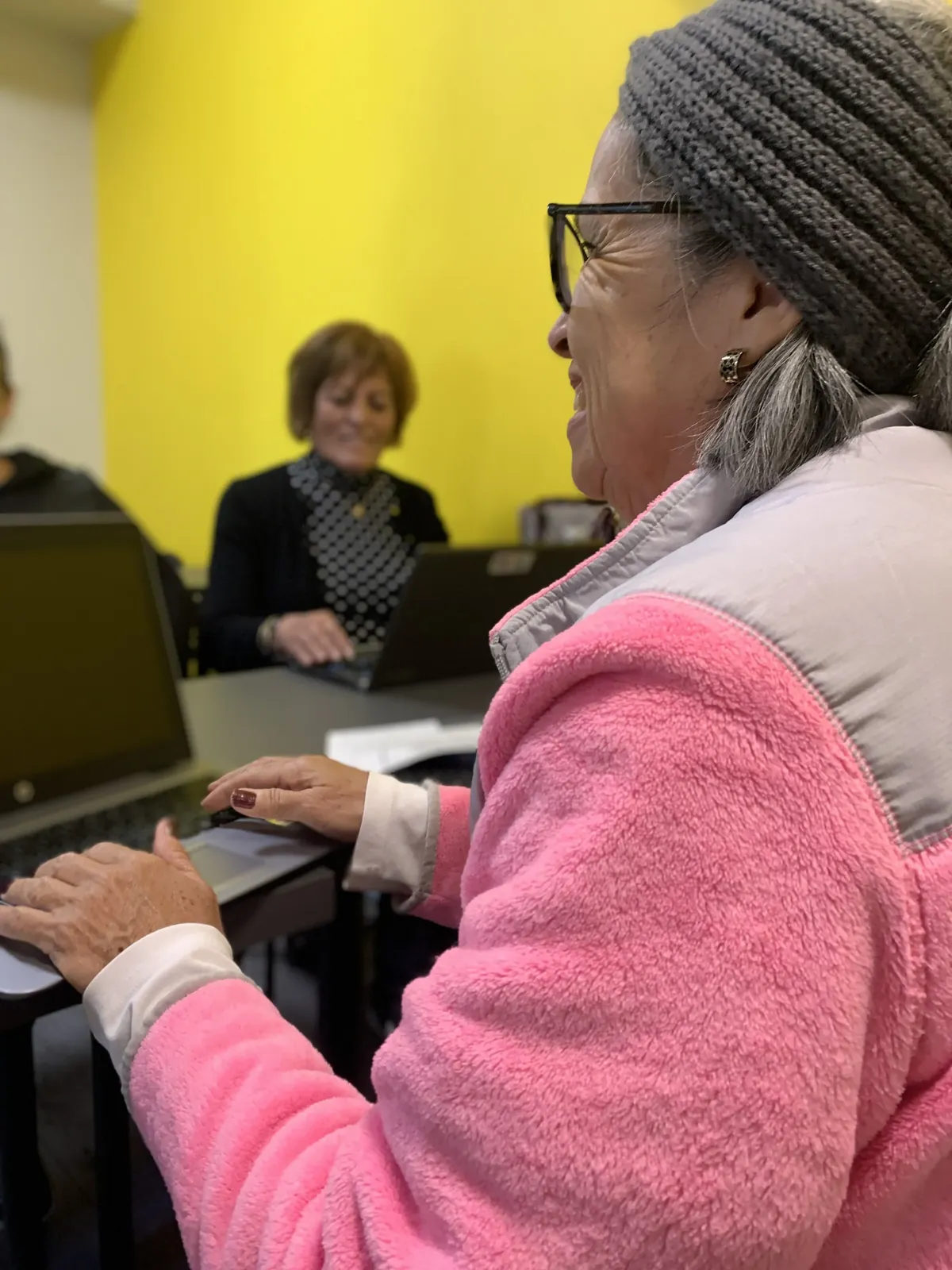Adults in a computer and English class at the center